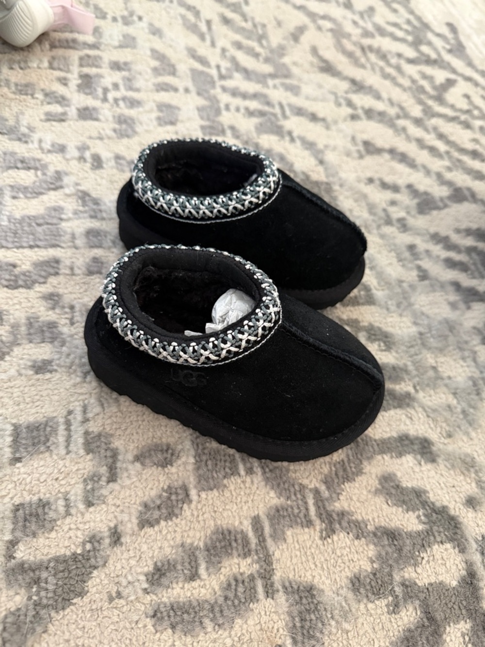 UGG Kids Black Slip-On Moccasin Slippers with Braided Trim